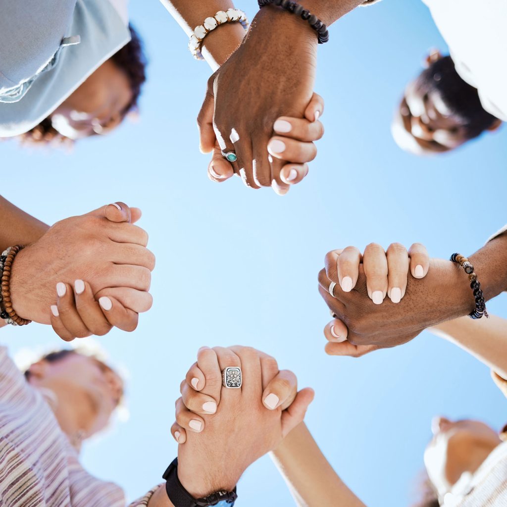 People in a circle clasping hands